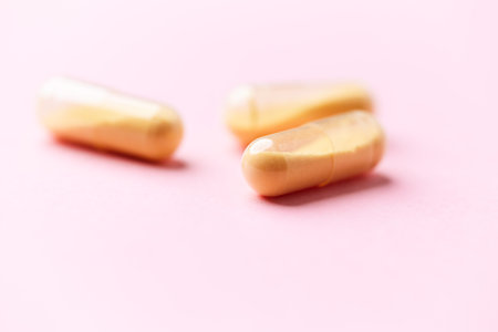 Capsules on a pink background.の写真素材