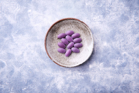 Lutein tablets. Diet supplement on wooden background. Soft focus. Top view. Close up. Copy space