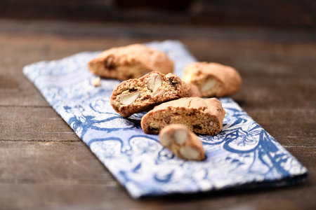 Italian cantuccini cookies on a blue napkin on a wooden backgroundの写真素材