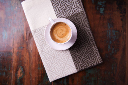 Coffee cup and napkin on old wooden table, stock photoの写真素材