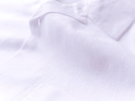 Close-up of white shirt with buttons.の写真素材