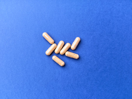 Pills on a blue background. Top view. Copy space.