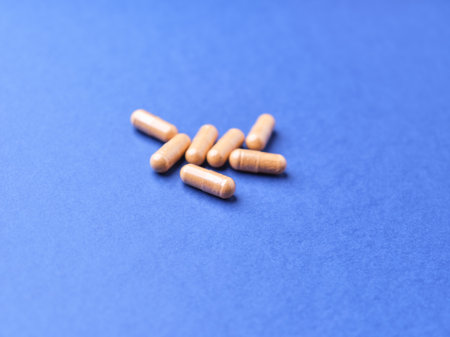 Pills on a blue background. Medicine and health care concept.の写真素材