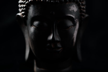 Buddha statue on black background, close-up image.の写真素材