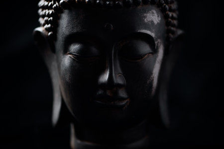 Buddha statue on black background, close-up image.の写真素材