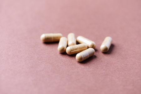 Capsules of dietary supplements on a brown background close-upの写真素材