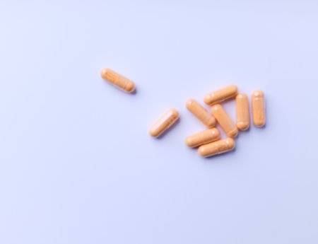 Capsule pills on a blue background. Close up.の写真素材