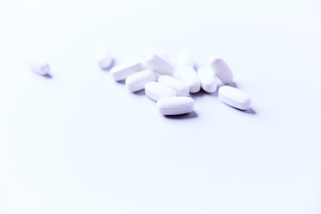 Pills on a white background. Focus on foreground, soft bokeh.