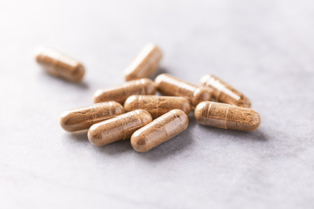 Herbal medicine capsules on a light background. Selective focus.の写真素材