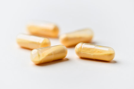 Capsules of omega 3 fish oil on a white background.