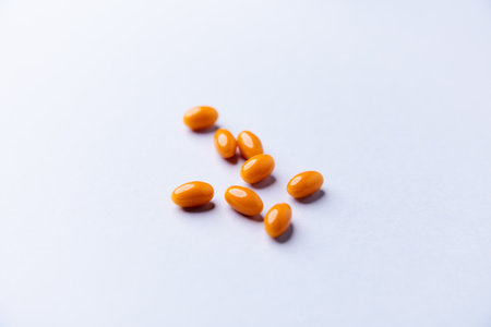 Orange pills isolated on white background. Close up. Copy space.の写真素材