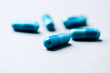 Blue pills on a white background. Shallow depth of field.の写真素材