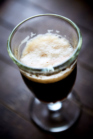 Coffee in a glass on a wooden table. Shallow depth of field
