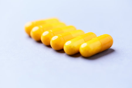 Yellow capsules on a blue background. Close-up of yellow capsules.の写真素材