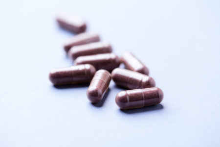 Close up of brown pills on blue background. Focus on foreground.の写真素材