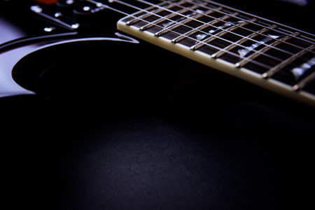 Close up of a black electric guitar with shallow depth of field.の写真素材