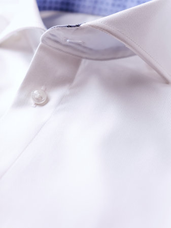 Closeup of a white shirt with buttons on a man's shirt