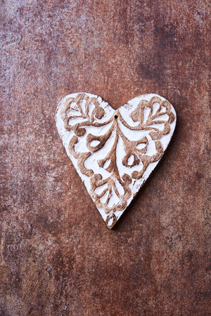 Wooden heart on rusty metal background. Love concept. Top view.の写真素材