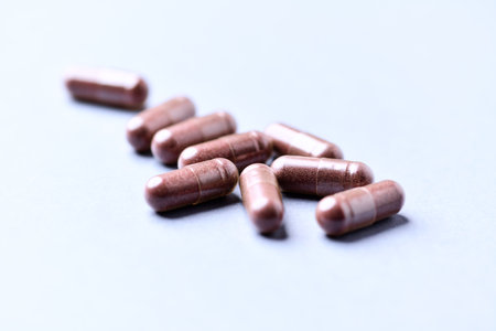 Capsules of medicine on a blue background close-up.の写真素材