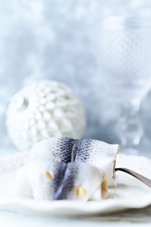 Frozen herring fillets on a white plate, selective focusの写真素材