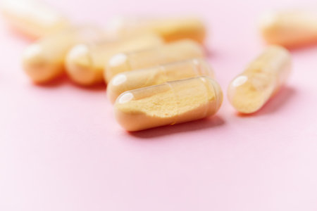 close up of capsules on pink background with copy space.の写真素材