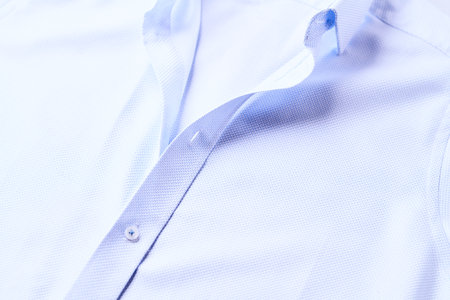 Men's shirt with blue collar, close-up. Shallow depth of field.