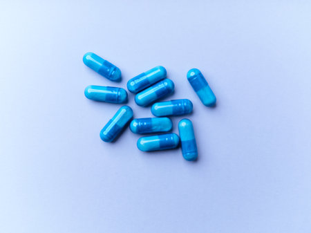 Blue pills on a blue background. Top view. Copy space.の写真素材