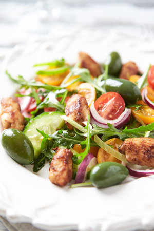 Salad with chicken, vegetables and arugula, selective focusの写真素材