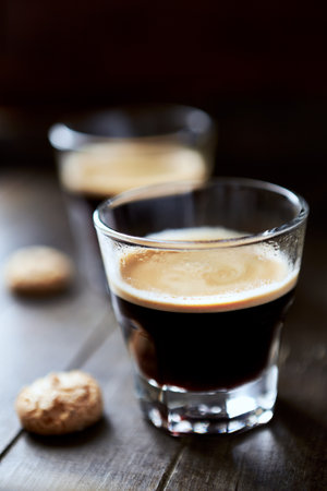 coffee in a glass and cookies on a wooden table, selective focusの写真素材