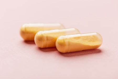 Capsules of omega 3 fish oil on a pink background.の写真素材