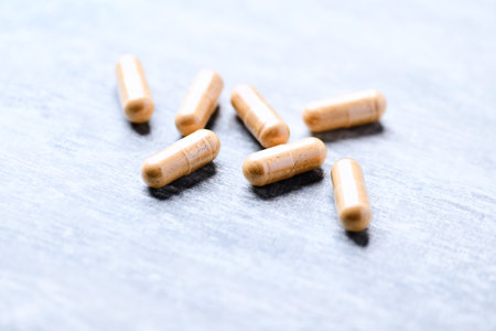 Close up of pills on wooden background. Focus on foreground, shallow DOF.の写真素材