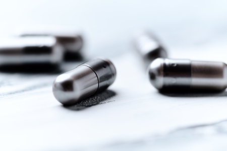 Pills on a wooden table. Focus on foreground, shallow depth of field.の写真素材