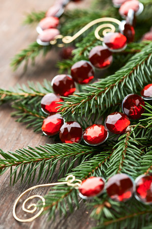 Christmas decoration with fir tree and beads on wooden background, closeupの写真素材