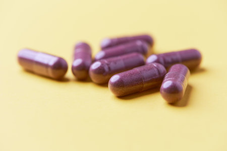 Medicine pills on a yellow background. Focus on foreground, soft bokeh.の写真素材