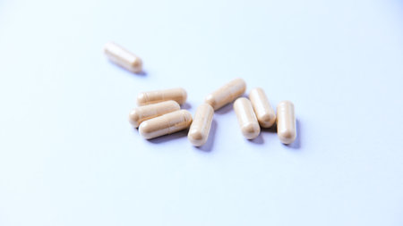 Close up of pills on white background. Focus on foreground, soft bokeh.