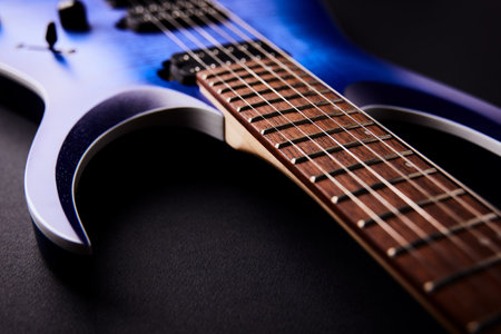 Blue electric guitar on a black background. Close-up, selective focus.の写真素材