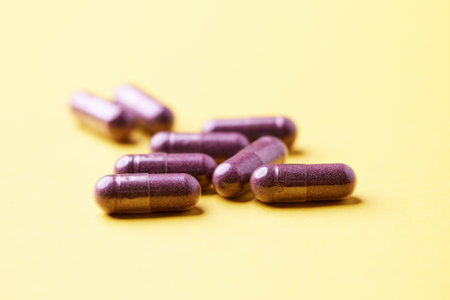 Medicine pills on yellow background. Focus on foreground, soft bokeh.の写真素材