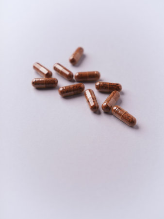 Capsules of brown color on a white background. Selective focus.の写真素材