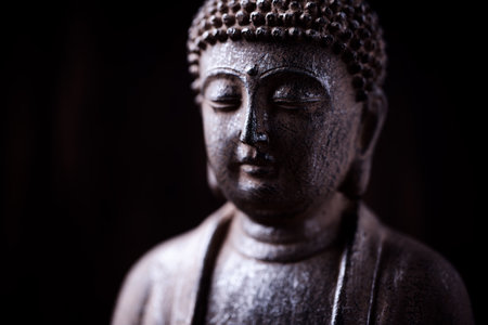 Buddha statue on a dark background. Selective focus.の写真素材