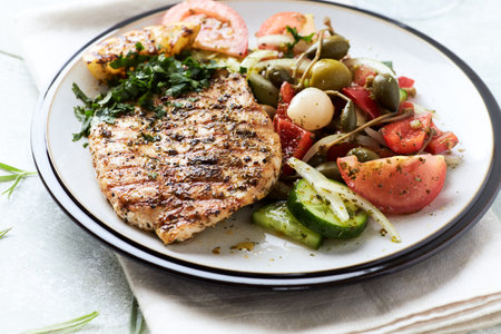 Grilled Chicken with Vegetable Salad on a White Plate.