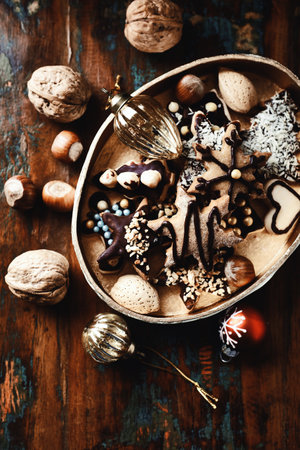 Christmas cookies with nuts and chocolate on a wooden background, top viewの写真素材