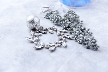 Silver jewelry on a light background, close-up, selective focusの写真素材
