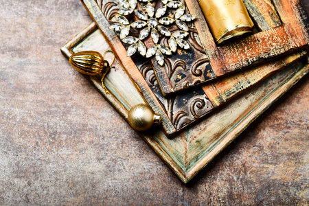 Vintage book and golden Christmas decorations on rustic background.の写真素材
