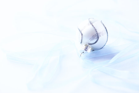 Christmas decoration on a white background with blue ribbons and Christmas ballsの写真素材