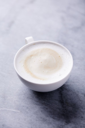 Cup of cappuccino or latte coffee tableの写真素材