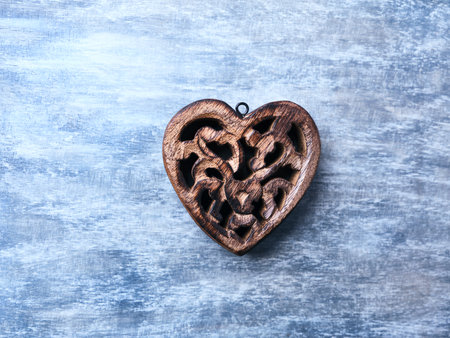 Wooden heart on blue wooden background, top view, copy spaceの写真素材