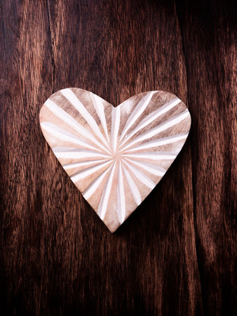 Wooden heart on a wooden background. Valentines day background.の写真素材