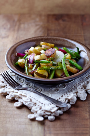 potato salad with green beans, onion and garlic, selective focusの写真素材