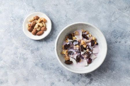 Healthy breakfast bowl with yogurt, granola, raisins and nuts.の写真素材