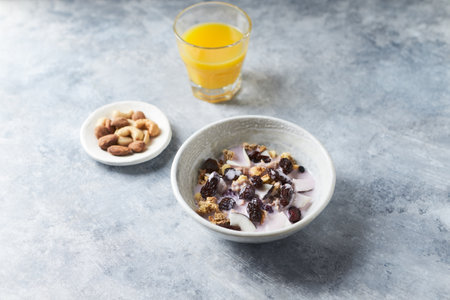 Healthy breakfast with muesli, yogurt, nuts and orange juiceの写真素材